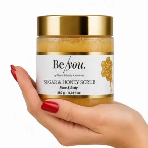 Hand holding the honey and sugar scrub product